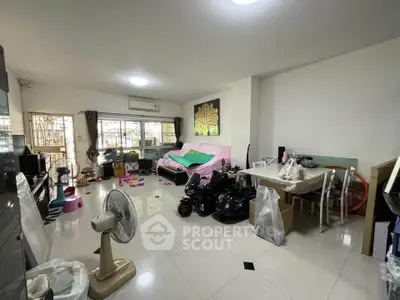 Spacious living room with modern decor and ample natural light, perfect for family gatherings.