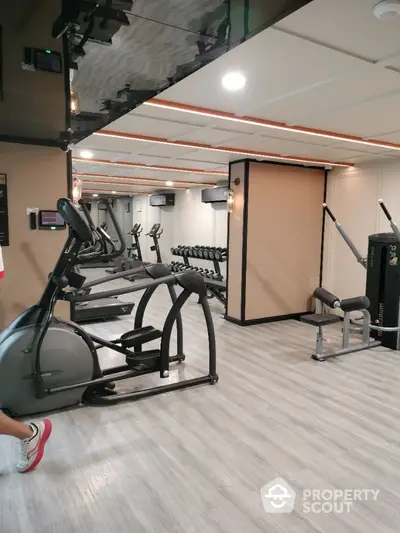 Modern gym with state-of-the-art equipment in luxury residential building.