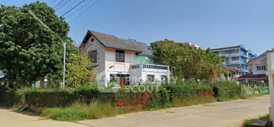 Charming suburban house with lush greenery and spacious surroundings, perfect for family living.