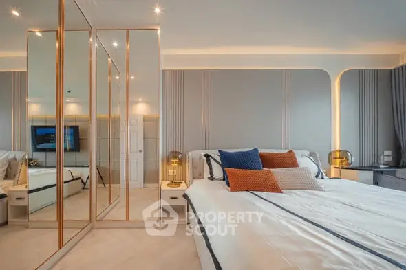 Luxurious bedroom with mirrored wardrobe and elegant lighting
