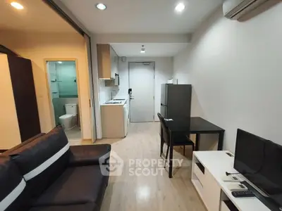 Modern apartment interior with open layout, featuring a cozy living area, compact kitchen, and sleek bathroom.