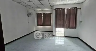 Spacious empty room with tiled floor and curtains, ideal for customization.