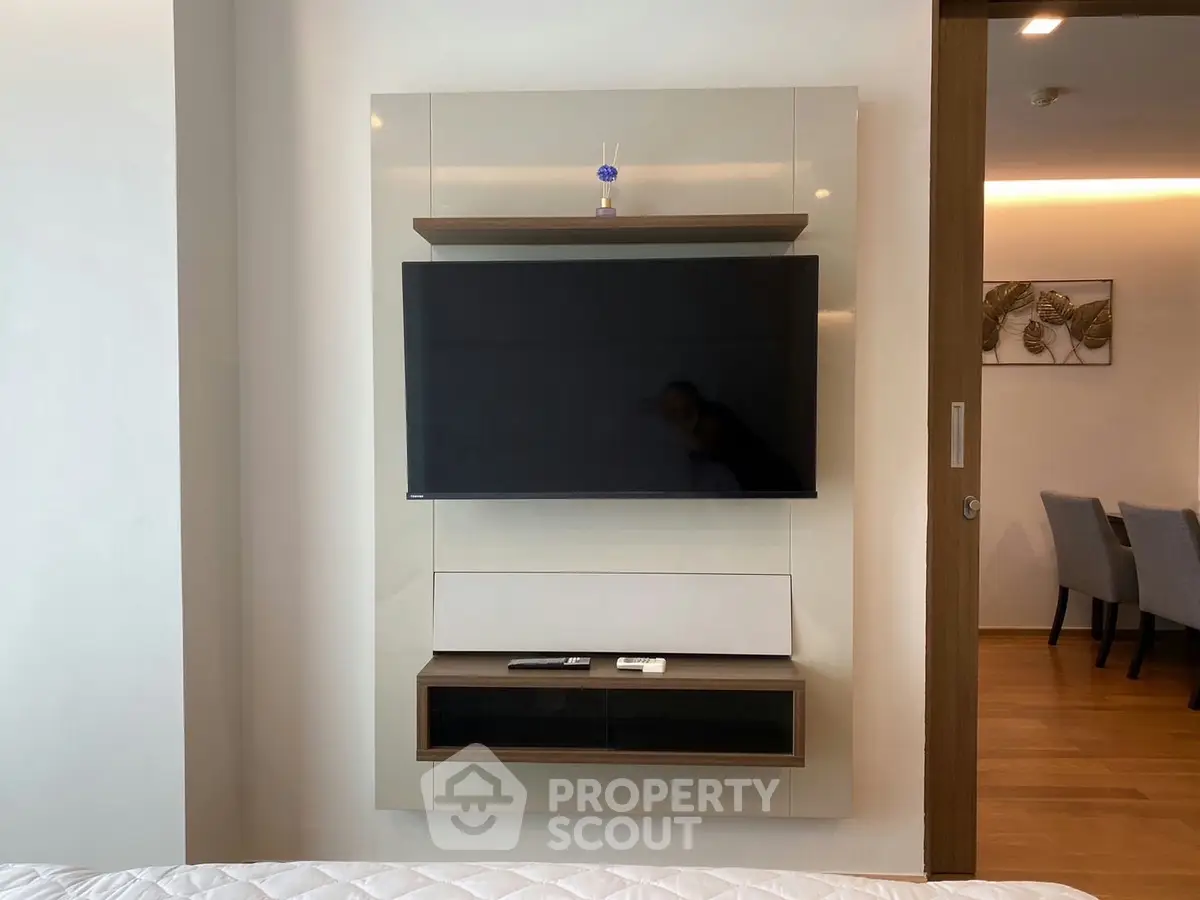 Modern living room with wall-mounted TV and sleek furniture design