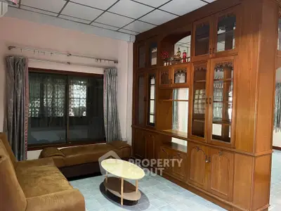 Spacious living room with elegant wooden cabinetry and cozy seating area.