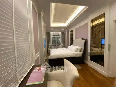 Luxurious bedroom with elegant decor and cozy ambiance, featuring a plush bed and stylish furnishings.