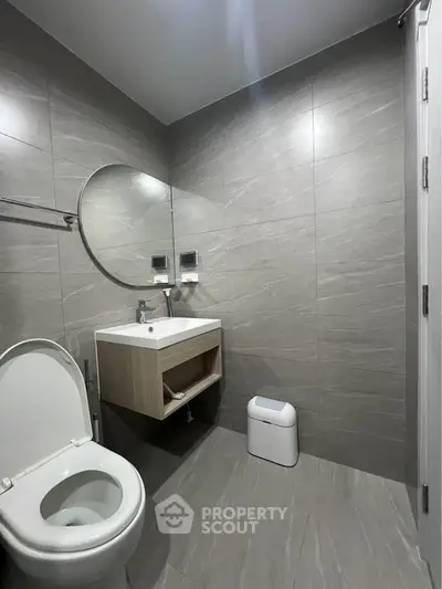 Modern bathroom with sleek gray tiles and minimalist fixtures