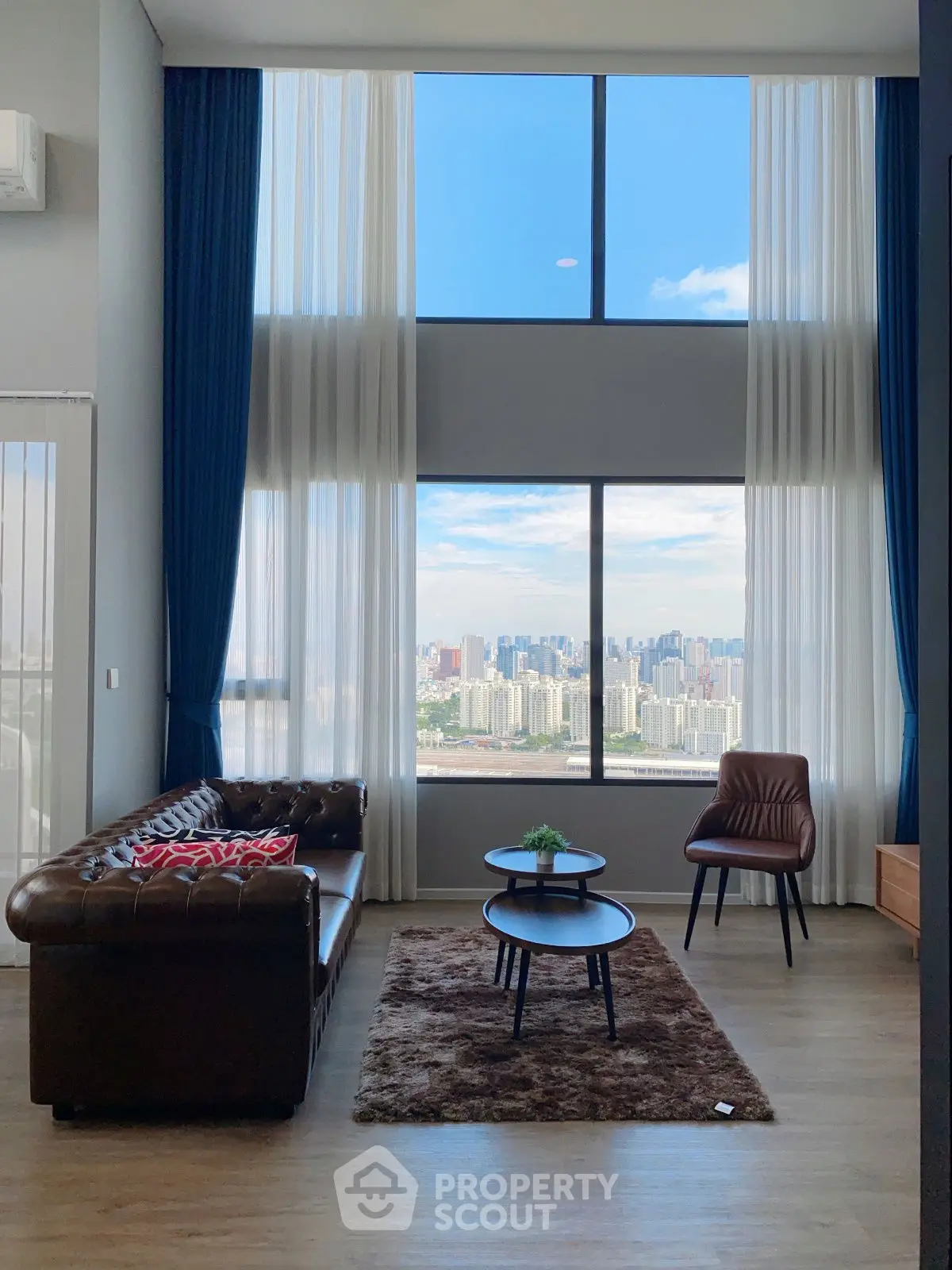 Luxurious living room with stunning city view and high ceilings