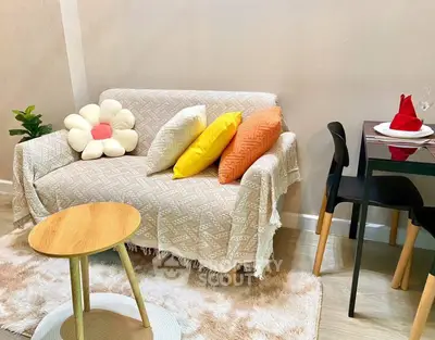 Cozy living room with stylish sofa and dining area, perfect for modern living.