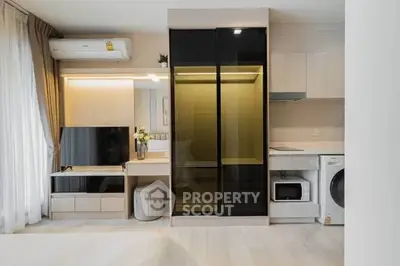 Modern apartment interior with sleek furniture and built-in appliances, featuring a stylish living area and efficient layout.