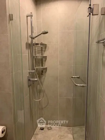 Modern bathroom with sleek glass shower enclosure and elegant tile design