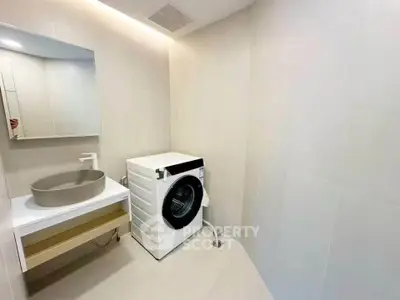 Modern bathroom with washing machine and sleek sink design
