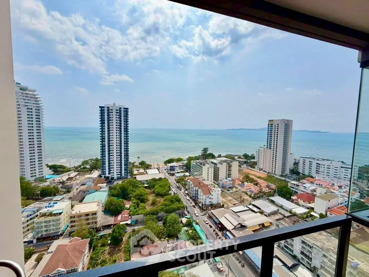 Stunning ocean view from high-rise balcony overlooking cityscape and coastline.