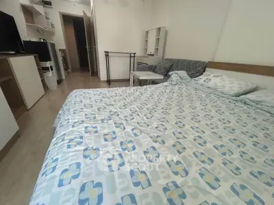 Cozy bedroom with modern decor and ample natural light, featuring a comfortable bed and stylish furnishings.