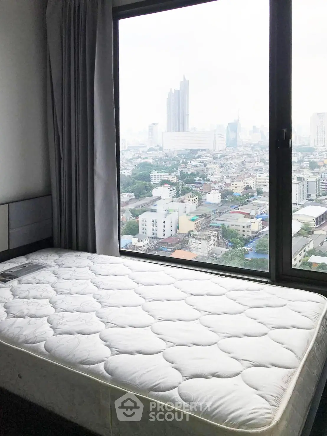 Spacious bedroom with stunning city view from large window