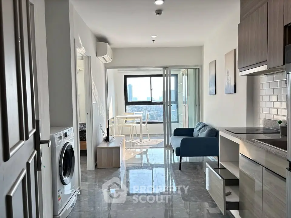 Modern apartment interior with open layout, featuring a cozy living area, kitchen, and city view balcony.