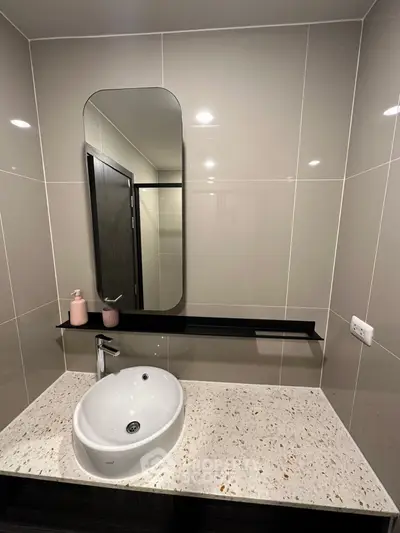 Modern bathroom with sleek mirror and stylish sink in contemporary design.