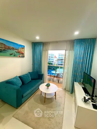 Stylish living room with vibrant teal sofa and balcony view in modern apartment