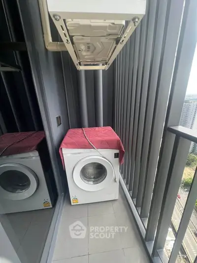 Modern balcony with washing machine and city view, perfect for urban living convenience.