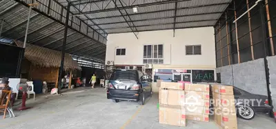 Spacious warehouse with ample storage and parking space, ideal for business operations.