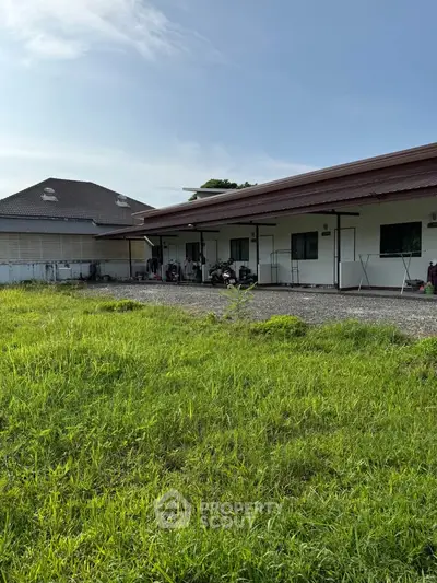 Charming single-story home with spacious green lawn and modern exterior design.