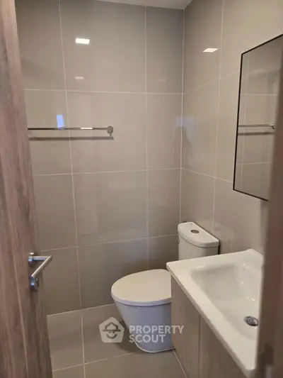 Modern bathroom with sleek fixtures and neutral tiles, perfect for a contemporary home.