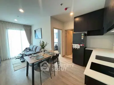 Modern open-plan living room and kitchen with stylish decor and natural light.