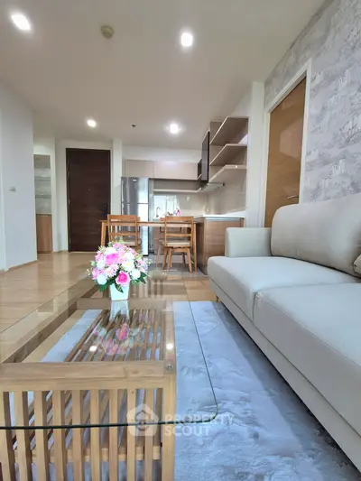 Modern living room with elegant decor and open kitchen layout