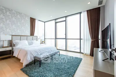 Luxurious modern bedroom with floor-to-ceiling windows and elegant decor in high-rise apartment.