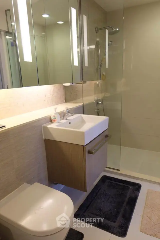 Modern bathroom with sleek fixtures and glass shower enclosure