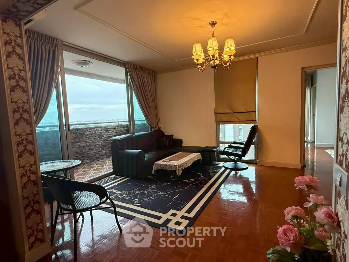 Elegant living room with balcony and stunning view, featuring classic decor and cozy seating area.