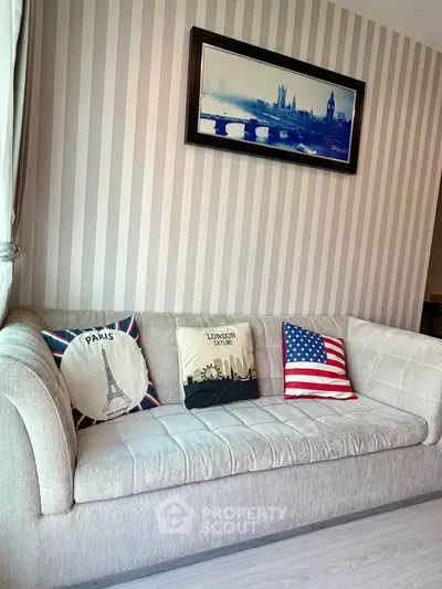 Stylish living room with cozy sofa and themed cushions, perfect for relaxation.