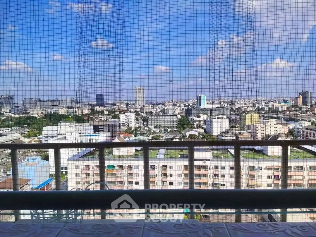 Stunning cityscape view from high-rise balcony with clear blue sky
