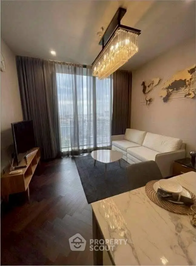 Luxurious living room with elegant chandelier and stunning city view