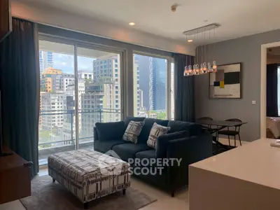 Modern living room with city view, stylish furniture, and elegant lighting in a high-rise apartment.
