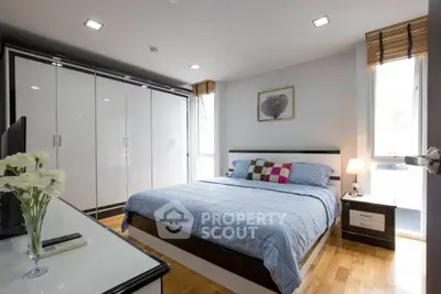 Spacious modern bedroom with large wardrobe and stylish decor