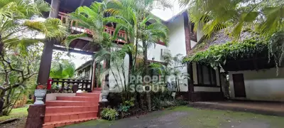 Charming tropical villa with lush garden and traditional architecture, perfect for serene living.