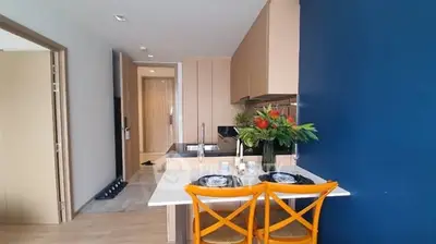 Modern kitchen with dining area and vibrant blue accent wall