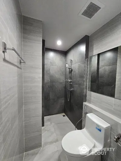 Modern bathroom with sleek gray tiles and contemporary fixtures