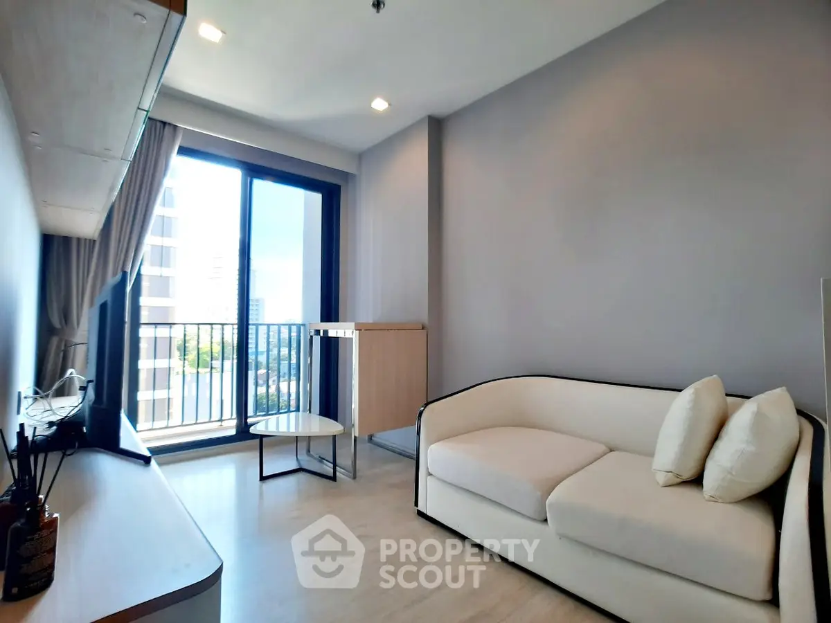 Modern living room with balcony view and stylish furniture