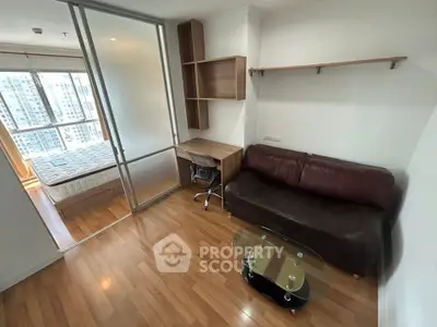 Modern apartment with cozy living area and bedroom, featuring wooden flooring and stylish furniture.