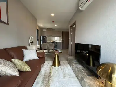 Modern living room with stylish decor and open kitchen layout in a contemporary apartment.