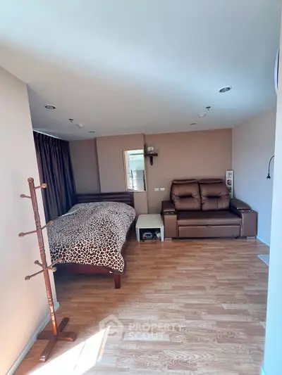 Cozy bedroom with stylish decor and comfortable seating area