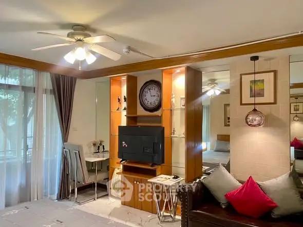 Charming living room with ceiling fan, cozy seating, and elegant decor, perfect for relaxation and entertainment.