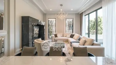 Luxurious modern living room with elegant chandelier and spacious seating area.
