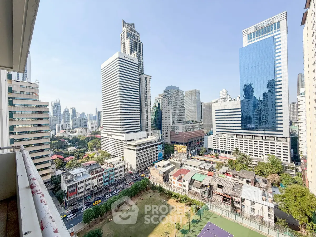 Stunning cityscape view from a high-rise balcony showcasing modern skyscrapers and urban landscape.