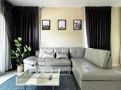 Modern living room with sleek gray sectional sofa and stylish decor