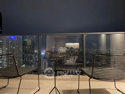 Stunning cityscape view from a modern balcony with sleek furniture, perfect for urban living.