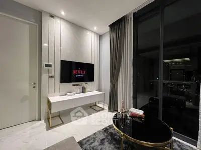 Luxurious modern living room with sleek TV setup and stunning night view.