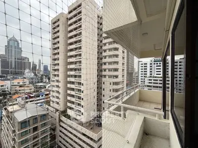 Stunning urban balcony view with high-rise buildings and cityscape.