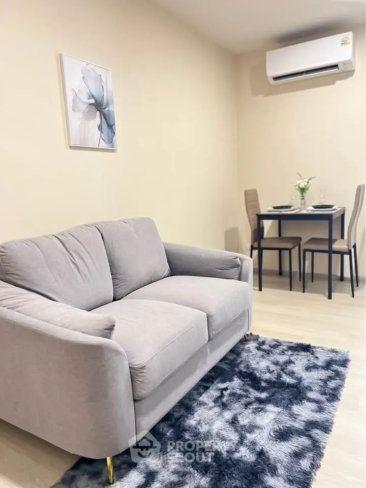 Cozy living room with modern sofa and dining area, perfect for urban living.